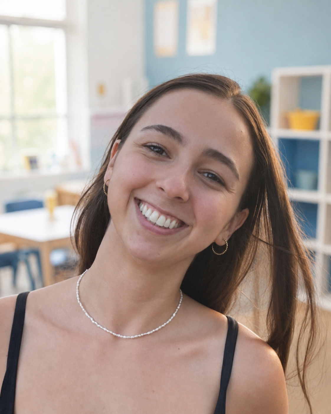 Teacher Carmen smiling in a bright classroom